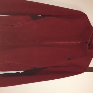 The North Face red zip up jacket.